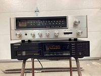 Front view of Samsui Model 221 stereo receiver stacked on Pioneer PD-M360 CD player showing controls and displays.