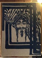 Full view of the vintage silkscreen artwork depicting a stylized hippie man with extended hair and beard creating a psychedelic pattern border on a beige fabric background.
