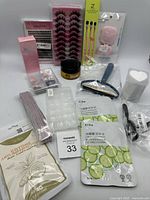 Photo of various beauty supplies including false eyelashes, cream, brushes, and masks arranged on white surface.