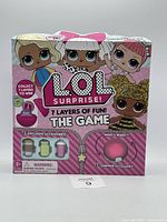 Front view of the unopened L.O.L. Surprise 7 Layers Of Fun! The Game packaging showing characters and accessory illustrations.