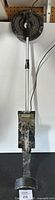 Full metal detector assembled with control unit, handle, and search coil laid out vertically showing full length and general condition.
