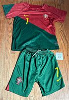 Front view of Portugal youth soccer jersey and matching shorts, showing colors, logos, and numbers.