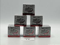 Five boxes of Treatonic Tattoo Numbing Cream arranged in a pyramid.