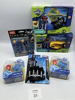 Photo showing assortment of toys including two Wild Quest Ocean Playsets, Mega Construx Halo figures, Marvel Black Panther figure, and two Blue's Clues 2-figure packs arranged on a white surface.