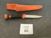 Vintage BAHCO Sweden cutting tool with wrapped handle and straight blade alongside orange plastic sheath
