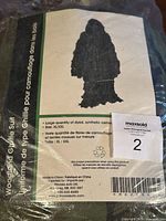 Photo of the packaging label showing product details, size XL/XXL, made in China, synthetic camo fibers.