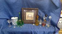 Complete view of all glassware, decanters, ice buckets, and the framed wall print showing the entire lot contents