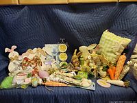 Overview of entire lot showing pillows, plates, bunny figurines, carrots, and various spring decor items.