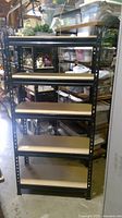 Front view of assembled 5 tier garage shelf unit with wood shelves and black metal frame.