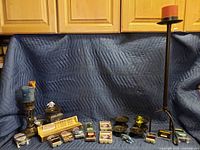 Overview of lot with candle sticks, figurines, wax melt warmer and wax melts, incense holders, cribbage board.