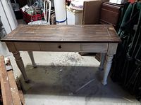 Front view of wooden sofa table showing dark stained top, painted legs, and drawer in closed position.