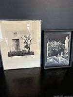 Two framed black and white artworks side by side: the oil on vinyl by John Ratekin on left and the signed photograph on right