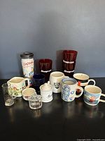 Various mugs, Snap-On glasses, creamer, sugar bowl, and travel mugs