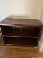 Full front view of the Pottery Barn bookcase showing two shelves and wood finish.