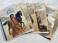 Six softcover American Girl 'Kaya' books fanned out showing front covers and titles.