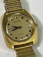 Close-up of watch face showing Andre Pailet branding, date display, and automatic text.