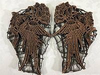 Pair of copper batik printing plates showing bird perched on a flower in a mirror image arrangement, detailed etching and cutwork.