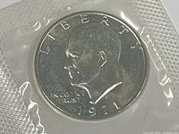 Obverse of the 1971-S Eisenhower Silver Dollar coin sealed in original packaging showing Eisenhower profile, date, and inscriptions.