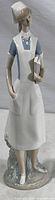 Full view of the Lladro nurse figurine, showing the entire standing figure and base.