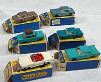 Lot of six vintage Matchbox cars on boxes showing overall assortment and condition