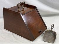 Front and side view of the Victorian mahogany coal scuttle box with hinged lid and included metal scoop on white background.