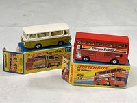 Photo showing two Matchbox Superfast buses with their original boxes: #12 Sentra Coach (white and olive green) and #17 The Londoner double decker (red with Berger Paints ads).