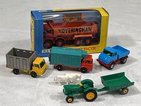 All five Matchbox toy trucks including boxed Foden tipper, cattle truck, refrigerator truck, Unimog, tractor and trailer with two bonus cows.