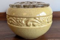 Side view showing yellow speckled ceramic planter with embossed decorative band.