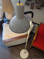 Full view of vintage floor lamp displaying adjustable metal dome-shaped shade, cream colored pole and base.