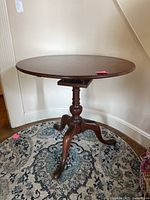 Front view of entire table showing round top and pedestal base