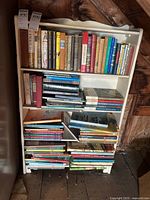 Shelf with various vintage books including history, children's books and classic literature
