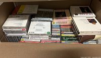 Full view of box containing numerous classical music CDs, jewel cases and box sets stacked