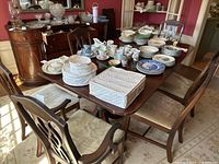 Six chairs arranged around dining table with other items on tabletop