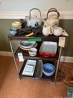 Front angle showing all three tiers of the metal rolling cart loaded with various kitchen items.