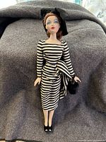Full body image of the Gene Marshall doll displaying her striped dress and black accessories.