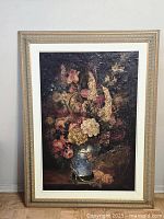Full frontal view of the framed floral still life painting