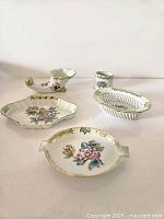 Front view of all five Herend pieces arranged on a flat surface