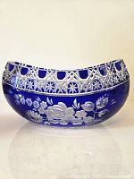 Front of cobalt blue crystal bowl showing floral engraving and lattice cut rim