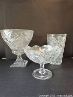 Photo showing the three crystal pieces side by side, illustrating their size and detailed cut patterns