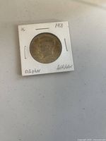 Obverse side of 1968 Kennedy half dollar in holder