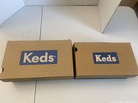 Two closed Keds shoe boxes