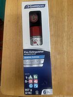 Front of boxed Garrison fire extinguisher showing weight, rating and model