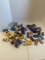 Group shot of over 25 toy vehicles spread on surface