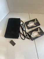 Front view of leather badge holder, lanyard, and two boxed airplane luggage tags