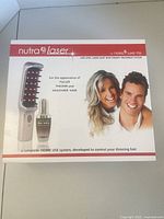 front of boxed Nutra Laser hair therapy system