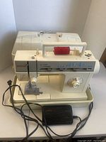 Singer sewing machine with foot pedal, cord, thread and case