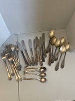 All 28 pieces of vintage Soviet flatware arranged by type