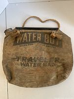 Front view showing printed lettering, tassel ends, overall wear