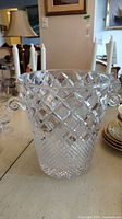 Front view of the clear crystal ice bucket with diamond cut and crosshatch pattern, showing one handle