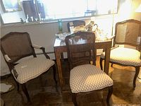Four chairs around a table, two armchairs at back and two side chairs at front